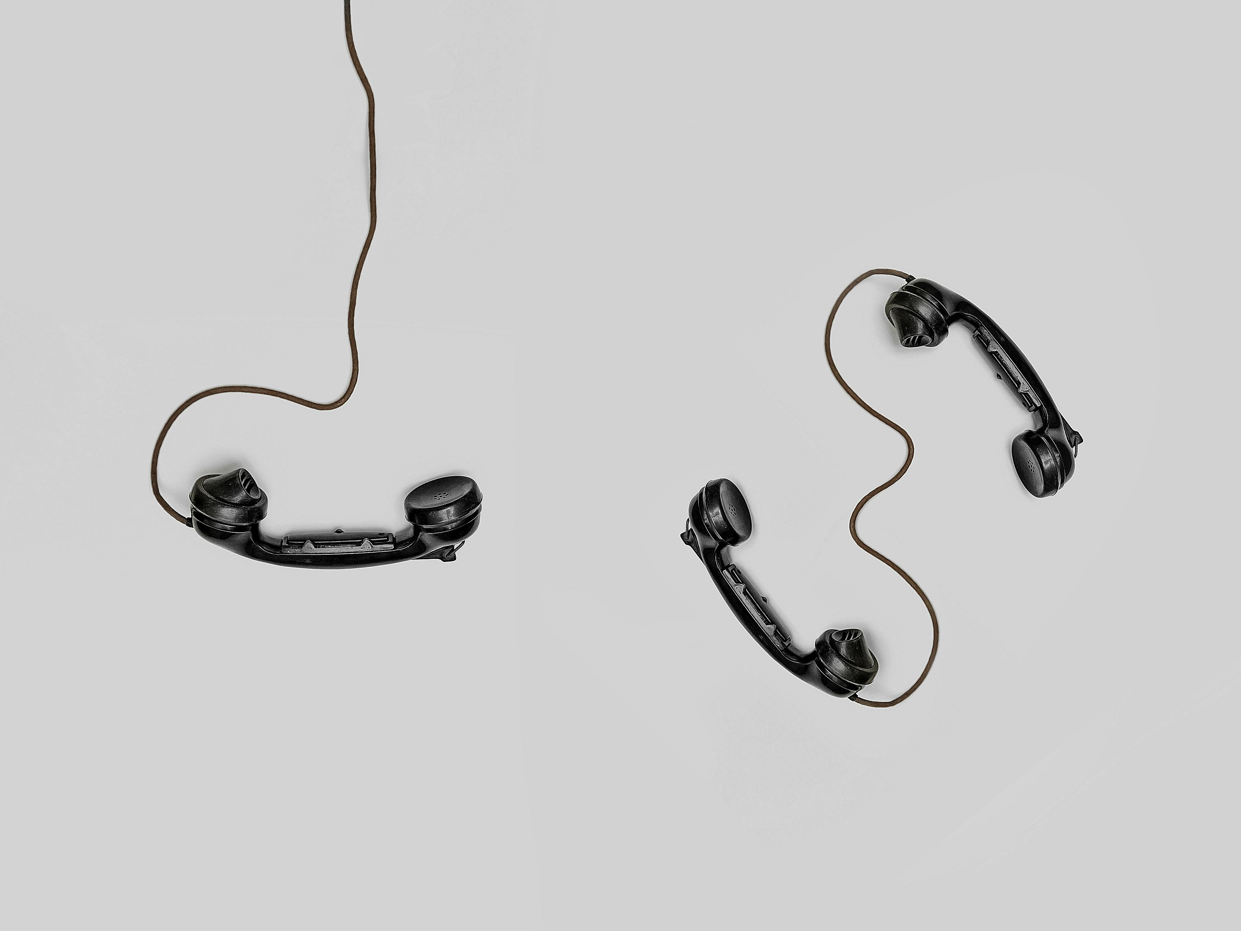 Two Old telephone headsets, signifying contact us